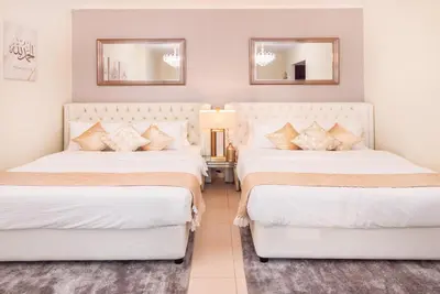 two beds in a room with two mirrors at Elite Royal Apartment - Full Burj Khalifa & Fountain View - Grace in Dubai