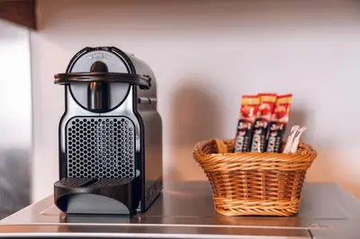 a coffee maker sitting on a counter next to a basket at Elite Royal Apartment - Full Burj Khalifa & Fountain View - Grace in Dubai