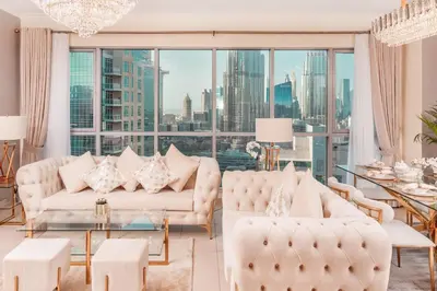 a living room with white furniture and a large window at Elite Royal Apartment - Full Burj Khalifa & Fountain View - Grace in Dubai