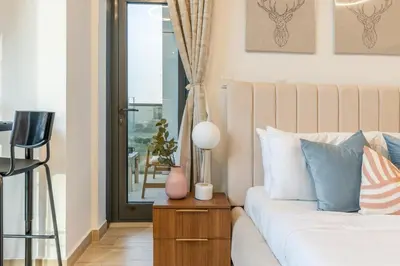 a living room with a couch and a window at GuestReady - Zen in the heart of JVC in Dubai