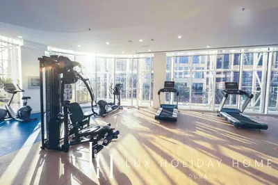 a gym with treadmills and ellipticals in a building at LUX The Pad Executive Suite Canal View 4 in Dubai