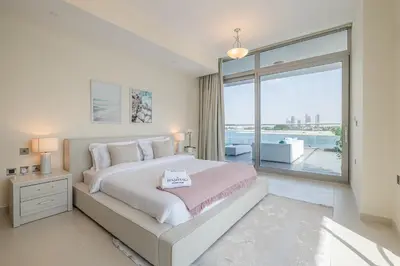 a bedroom with a large bed and a large window at 2BDR apartment with full sea view and Dubai Marina view Azure Residences in Dubai