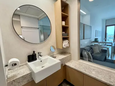 a bathroom with a sink and a mirror at Palm Jumeirah Upgraded & Cozy Boutique Apartment in Dubai