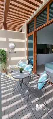 a patio with a table and chairs on a deck at Palm Jumeirah Upgraded & Cozy Boutique Apartment in Dubai