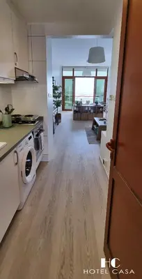 a kitchen and living room with a washer and dryer at Palm Jumeirah Upgraded & Cozy Boutique Apartment in Dubai