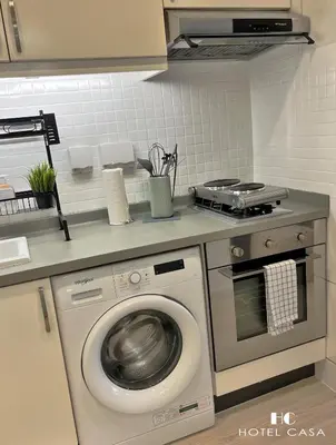 a kitchen with a washing machine and a stove at Palm Jumeirah Upgraded & Cozy Boutique Apartment in Dubai