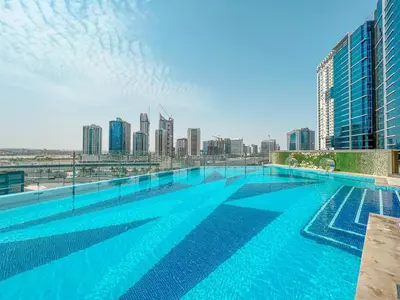 a large swimming pool on the roof of a building at Trophy - Downtown Scape Views Suite in Dubai