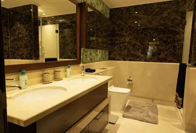 a bathroom with a sink and a toilet and a mirror at Luxury 3 BR - Direct View to Burj Khalifa in Dubai