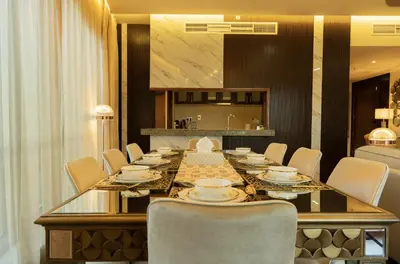a dining room with a long table and chairs at Luxury 3 BR - Direct View to Burj Khalifa in Dubai