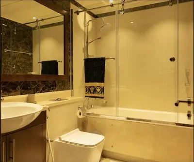 a bathroom with a toilet and a sink and a shower at Luxury 3 BR - Direct View to Burj Khalifa in Dubai