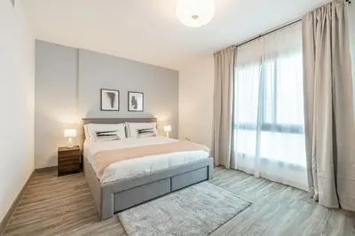 a bedroom with a bed and a large window at 1BDR Apartment in Dubai Marina with Marina Views in Dubai