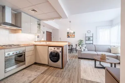 a kitchen and living room with a washer and dryer at 1BDR Apartment in Dubai Marina with Marina Views in Dubai