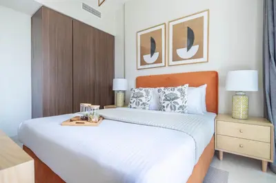 a bedroom with a large bed with a wooden headboard at Frank Porter - Vera Residence in Dubai