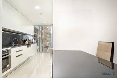 a kitchen with white cabinets and a counter top at Marina Canal Views 1BR Minutes Away from Marina Mall, The Address Residences, Dubai Marina by Deluxe Holiday Homes in Dubai
