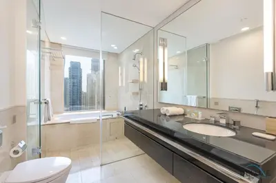 a bathroom with a sink and a toilet and a mirror at Marina Canal Views 1BR Minutes Away from Marina Mall, The Address Residences, Dubai Marina by Deluxe Holiday Homes in Dubai