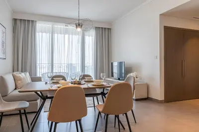 a dining room with a table and chairs at Spacious 2BDR in Creek Harbor with City View in Dubai