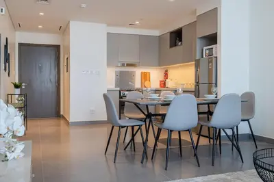 a kitchen and dining room with a table and chairs at Spacious 2BDR in Creek Harbor with City View in Dubai
