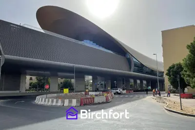 a large building in a parking lot with people outside at Birchfort - Newly renovated unique 1 bedroom apartment in Dubai
