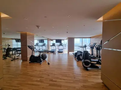 a gym with treadmills and cardio equipment in a building at Gala Guests - Carson Studio Collection in Dubai