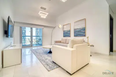 a living room with a couch and a table at Sea Views from Living to Bedroom Perfect for Staycation, Dubai Marina by Deluxe Holiday Homes in Dubai