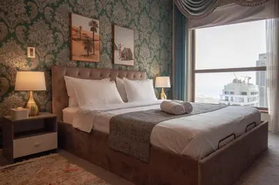 a bedroom with a large bed with a large window at La Buena Vida Holiday Homes - Beach front very spacious, luxe and modern 3 bedroom with full kitchen in JBR , 3 min to the JBR beach Dubai Marina and Tram Station in Dubai