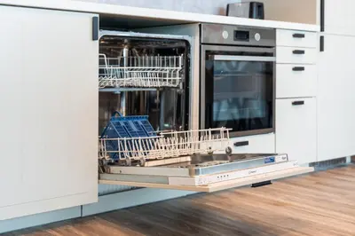 a dishwasher with dishes in it in a kitchen at Modern & Spacious 2-Bed Condo with Panoramic Lake Views, Dual Balconies, Steps from Dubai JLT Metro By 