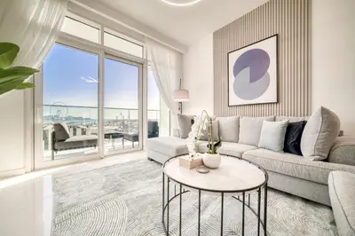 a living room with a couch and a table at Emaar Beach Front 2BR with Sea & Marina Skyline Views in Dubai