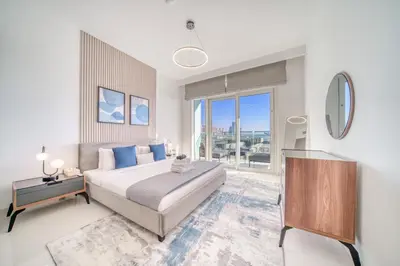 a bedroom with a large bed and a large window at Emaar Beach Front 2BR with Sea & Marina Skyline Views in Dubai