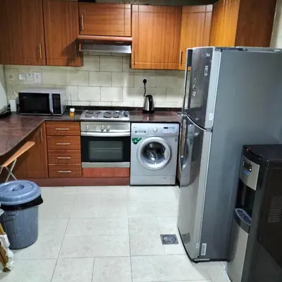 a kitchen with a refrigerator and a washing machine at Amazing apartment 2 bed rooms in Tecom 6 pax in Dubai