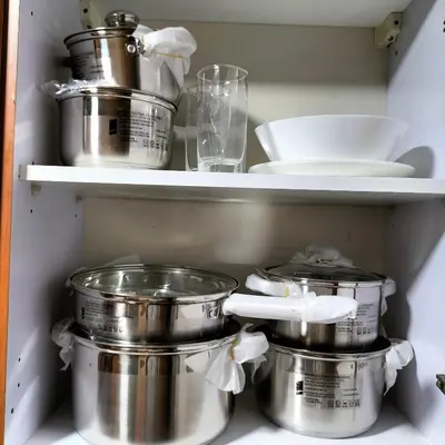 a shelf with pots and pans in a kitchen at Amazing apartment 2 bed rooms in Tecom 6 pax in Dubai