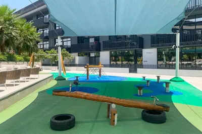 a resort with a playground with a slide and tires at Frank Porter - Belgravia 3 in Dubai
