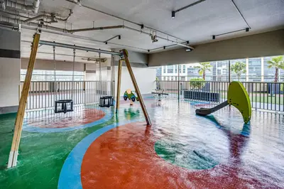 a large room with a pool with slides and swings at Amazing Burj Khalifa view from Brand new apartment in Dubai