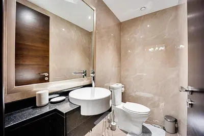 a bathroom with a white toilet and a mirror at Amazing Burj Khalifa view from Brand new apartment in Dubai