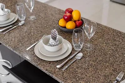 a table with a bowl of fruit and a plate of food at Cute 1BR - Dubai Marina Views - Walk 9min to Beach in Dubai