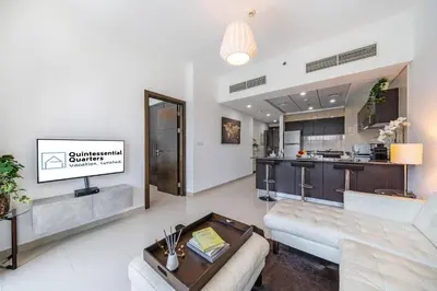 a living room with a couch and a kitchen at Cute 1BR - Dubai Marina Views - Walk 9min to Beach in Dubai