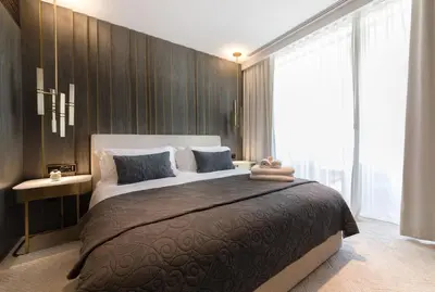 a bedroom with a large bed and a large window at Maison Privee - Luxury Sea View Apt in FIVE Resort on The Palm in Dubai