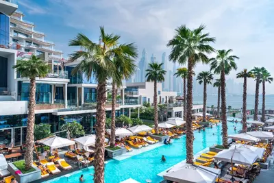 an aerial view of a resort pool with palm trees at Maison Privee - Luxury Sea View Apt in FIVE Resort on The Palm in Dubai