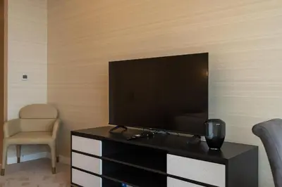 a flat screen tv sitting on top of a dresser at Palm Tower where Luxury & View meet in one place in Dubai