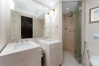 a bathroom with two sinks and a shower at Maison Privee - Elite Apt Connected to Dubai Mall & Burj Khalifa in Dubai