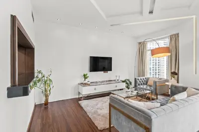 a living room with a couch and a tv at The Lofts - Luxurious space with Burj Khalifa View in Dubai