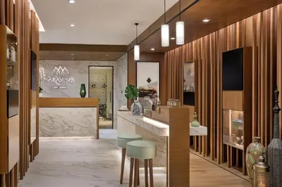 a lobby of a store with stools and a counter at Marriott Resort Palm Jumeirah, Dubai in Dubai