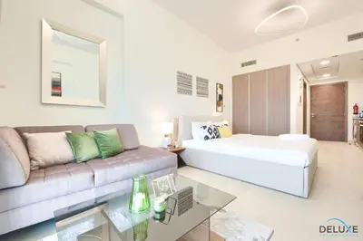 a living room with a bed and a couch at Perfect Studio Getaway Next to the Iconic Creek Harbour, Azizi Aliyah, Al Jaddaf, by Deluxe Holiday Homes in Dubai