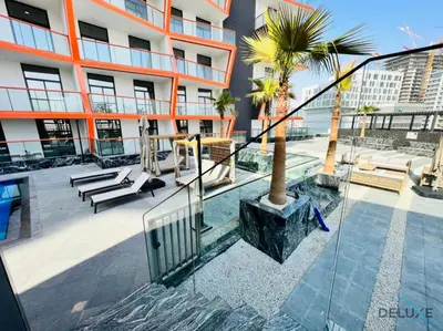 a balcony of a building with a palm tree at Homely 1BR at Binghatti Avenue Al Jaddaf by Deluxe Holiday Homes in Dubai