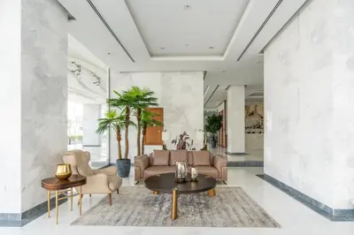 a lobby with a couch and chairs and a table at GlobalStay Business Bay Waves Tower Apartments Dubai in Dubai