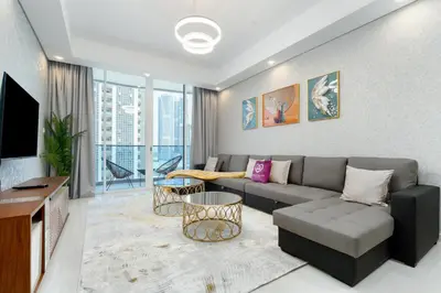 a living room with a couch and a tv at GlobalStay Business Bay Waves Tower Apartments Dubai in Dubai