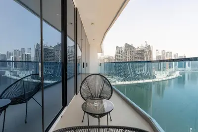 a balcony with two chairs and a view of the city at GlobalStay Business Bay Waves Tower Apartments Dubai in Dubai