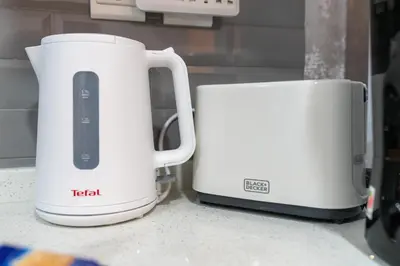 two white toasters sitting next to each other on a counter at GlobalStay Business Bay Waves Tower Apartments Dubai in Dubai