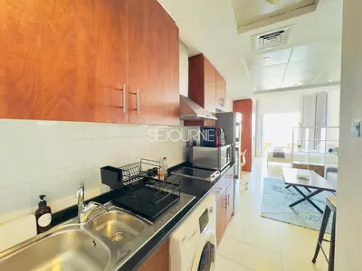 a kitchen with a sink and a stove at LV13 - Elegant Studio in Lake View Tower in Dubai