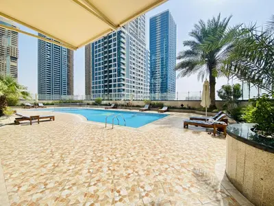 a swimming pool in a building with tall buildings at LV13 - Elegant Studio in Lake View Tower in Dubai
