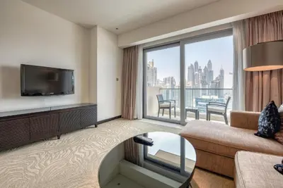 a living room with a couch and a large window at Graceful 1BR at The Address Residences Dubai Marina by Deluxe Holiday Homes in Dubai